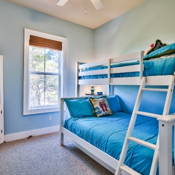 Bunkroom features full-sized bed, full-size pullout trundle, and twin upper bed