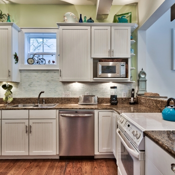 Kitchen open to dining, connected to mud room,washer dryer & exit behind door.